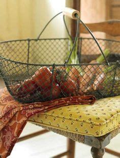 A Metal Basket Filled With Vegetables Sitting On Top Of A Yellow Chair