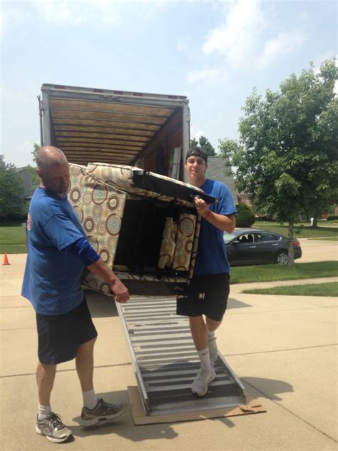 Twin City Movers Unload Furniture From The Moving Truck Twin City