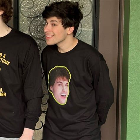 two young men standing next to each other wearing t - shirts with the ...