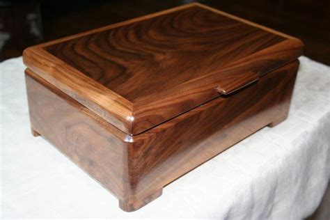 A Wooden Box Sitting On Top Of A White Cloth