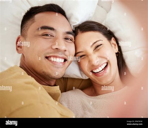 A Happy And In Love Couple Taking A Selfie While Smiling Laughing And