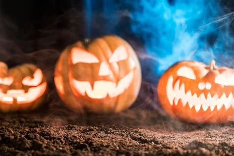 Premium Photo Spooky Carved Pumpkins With Smoke