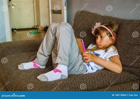 Girl Using Digital Tablet On Sofa At Home Stock Photo Image Of