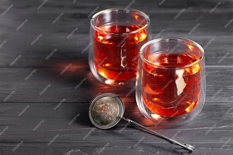 Premium Photo Glass Cup Of Tea On Wooden Board