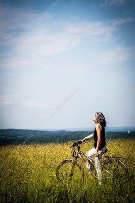 Woman Riding Bicycle Stock Image C Science Photo Library