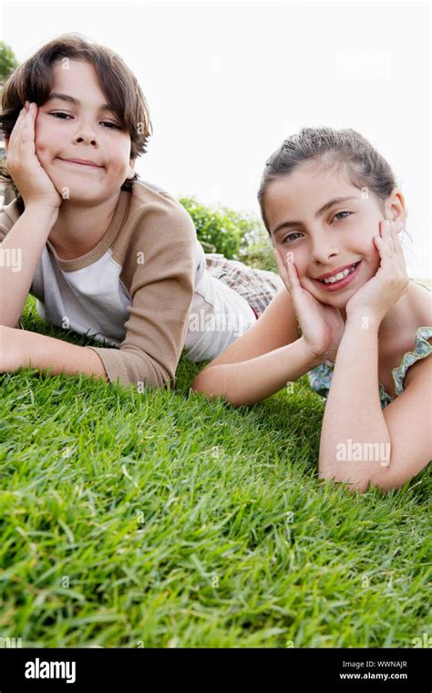 Children Lying on the Grass Stock Photo - Alamy