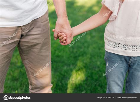 Family holding hands — Stock Photo © IgorVetushko #163069374