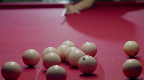 Triangle of billiard balls is disrupted by a powerful impact at the