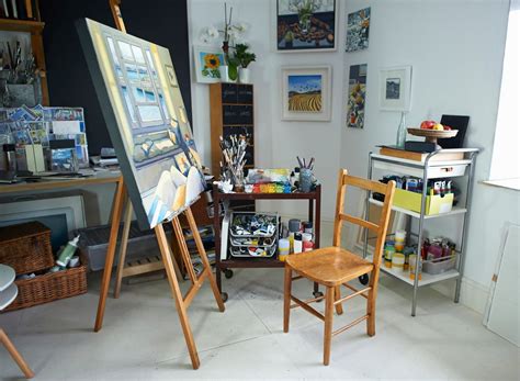 an artist's studio with easel, canvass and other art supplies in it