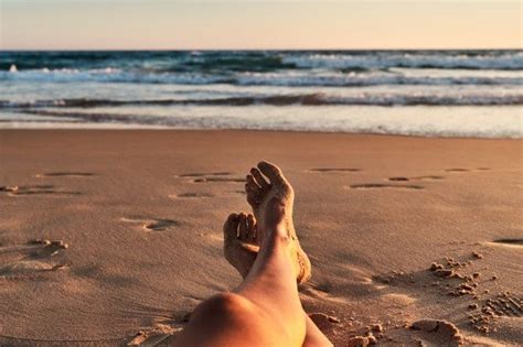 Pernas das mulheres na praia ao pôr do sol Foto Premium Fotos Por