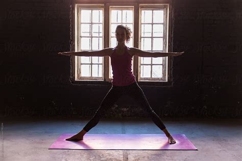 "Woman Doing Warrior Yoga Pose In A Studio" by Stocksy Contributor ...