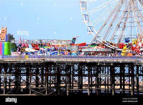 Fairground rides, amusements and a big wheel on the Central Pier in Blackpool, England, United ...