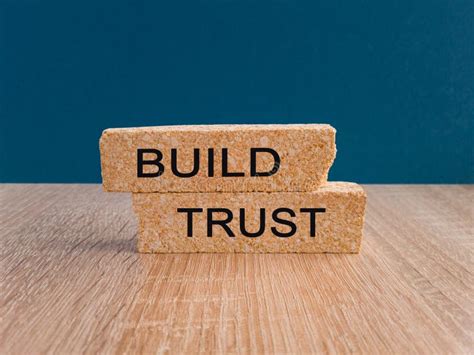 Build Trust Symbol. Concept Words Build Trust on Brick Blocks on a Beautiful Wooden Table, Dark ...