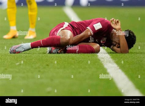 Qatar S Homam Ahmed Lies On The Pitch In Pain During The World Cup