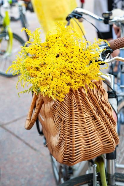 Premium Photo | Basket with yellow flowers on a bicycle creative decoration