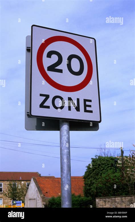 20 Miles Per Hour Speed Limit Zone Warning Sign On Road Through Village