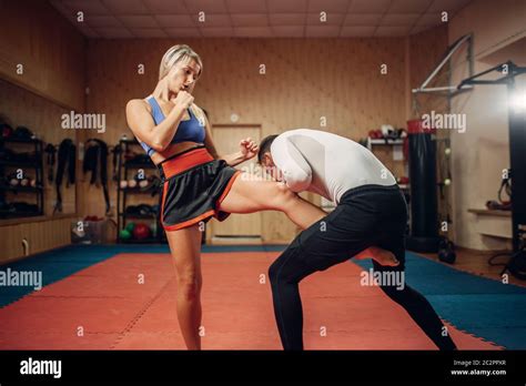 Female Person Makes A Kick In The Groin Self Defense Workout With Male Personal Trainer Gym