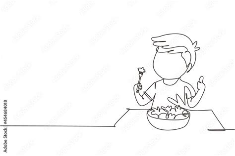 Single one line drawing little boy eating fresh vegetable salad and showing thumb up sign. Child ...