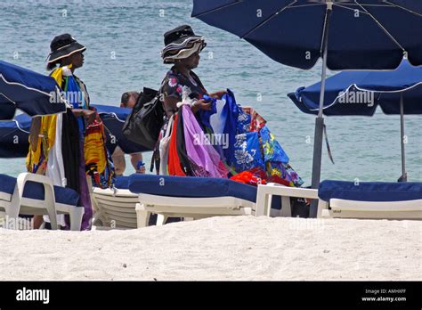 Women Selling Hats And Beach Towels Walk Among Sun Loungers Great Bay