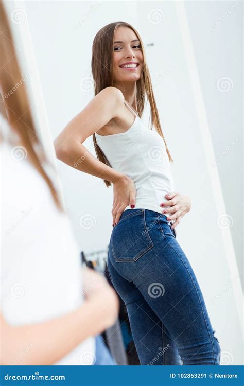 Beautiful Young Woman Looking Herself Reflection In Mirror At Home