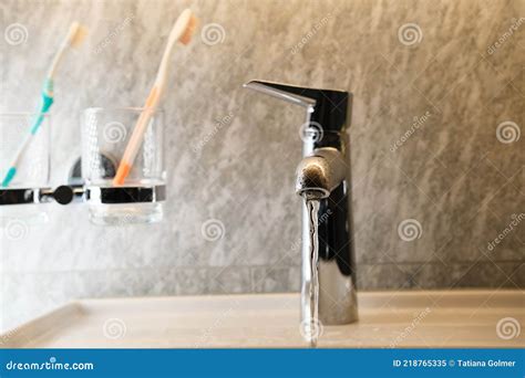 Water Pours A Thin Stream From A Chrome Plated Faucet Bathroom