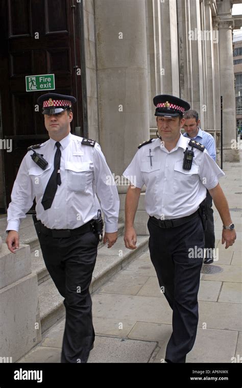 Two Male London Metropolitan Police officers walking the streets of the ...