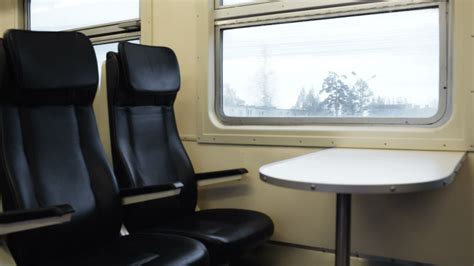 Two empty seats with table in the moving train 30248363 Stock Video at Vecteezy