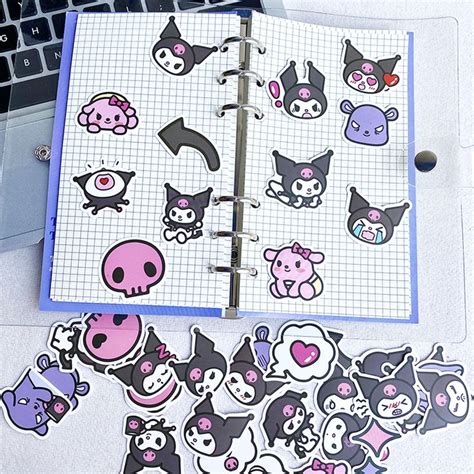 an open notebook with stickers on it next to a computer keyboard and ...