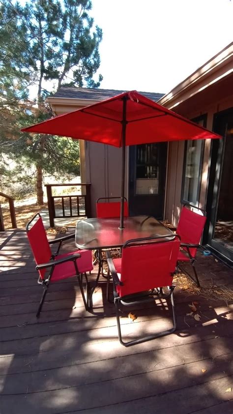 FROSTED GLASS PATIO TABLE-UMBRELLA-FOUR FOLDING CHAIRS | EstateSales.org