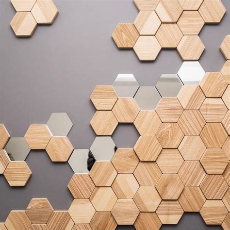 The Wall Is Made Up Of Wooden Hexagons With Mirrors On Each Side