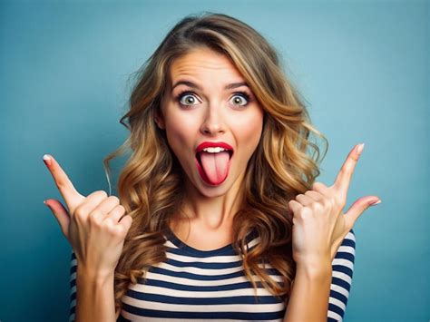 A Young Women Making A Playful Face With Her Tongue Out And Fingers