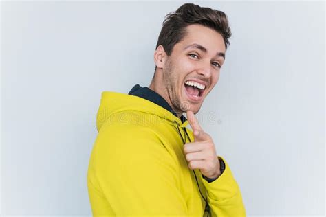 Portrait Of Smiling Handsome Male Worker Keeps Hand Under Chin Wears