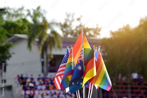 Rainbow flags and flags of many countries in front of green grasslawn ...