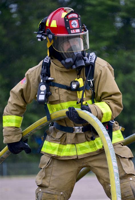 Nebraska Army National Guard Sgt. Marco Flores holds a fire hose during