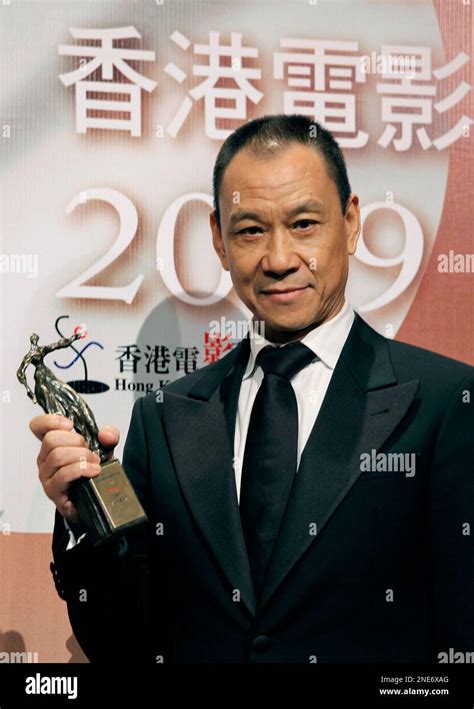 Chinese actor Wang Xueqi poses with his best actor award for his role ...