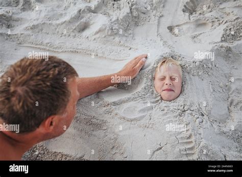 Man Buried Beach Hi Res Stock Photography And Images Alamy