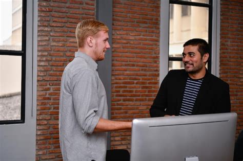 Premium Photo Businessmen Discussing While Standing In Office