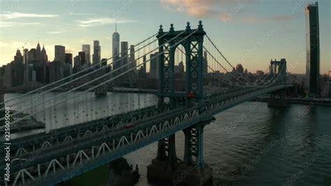 flying alongside Manhattan Bridge towards sunset view of NYC Stock ...