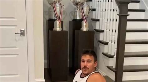 Brooks Koepka works out and flexes his major championship trophies