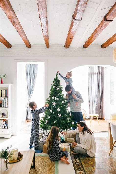 "Family Decorating Christmas Tree At Home." by Stocksy Contributor ...