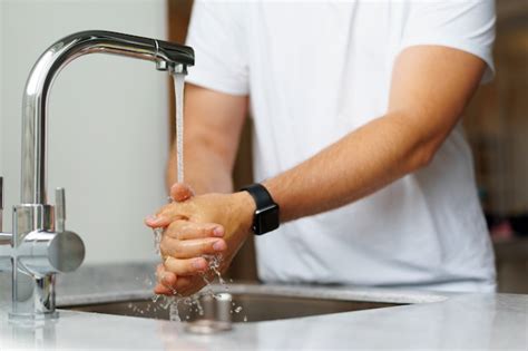 Premium Photo Man Washing Hands With Soap In A Sink At His Home