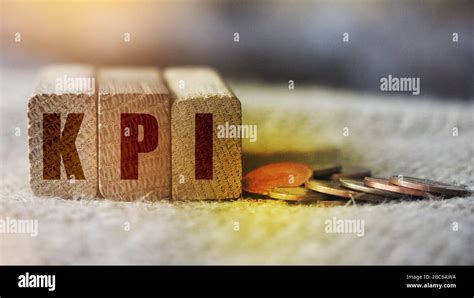 Kpi Word Written In Wooden Cubes And Coins On Burlap Canvas Key