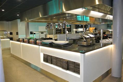 A Restaurant Kitchen With Stainless Steel Appliances And Counter Tops