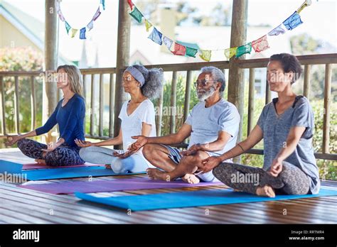 Serene People Meditating In Hut During Yoga Retreat Stock Photo Alamy