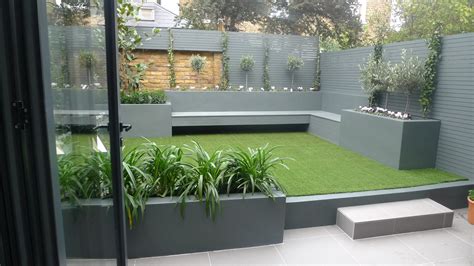 Modern small low maintenance garden fake grass grey raised beds ...