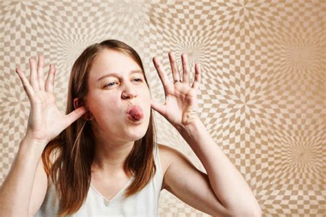 Young Woman With Funny Face Mocking Someone Sticking Tongue Out Stock