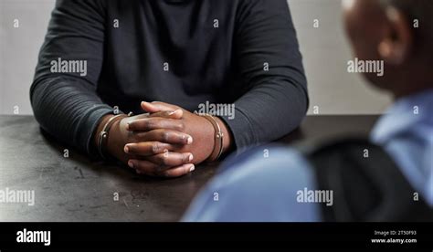 criminal hands  handcuffs  table  interrogation questions