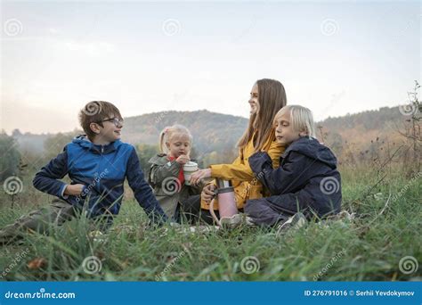 Happy Mom And Three Kids Have Fun At Picnic Two Boys And Girl With