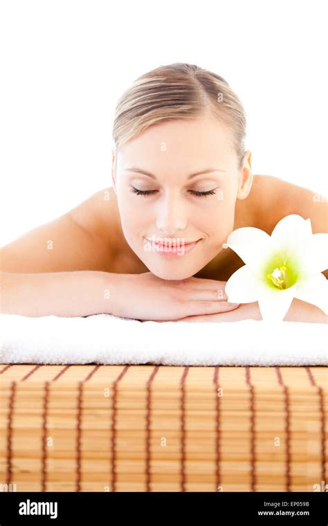 Close Up Of A Delighted Woman Lying On A Massage Table With A Flower In