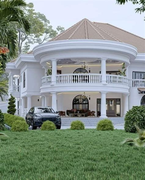 A Large White House Sitting On Top Of A Lush Green Field